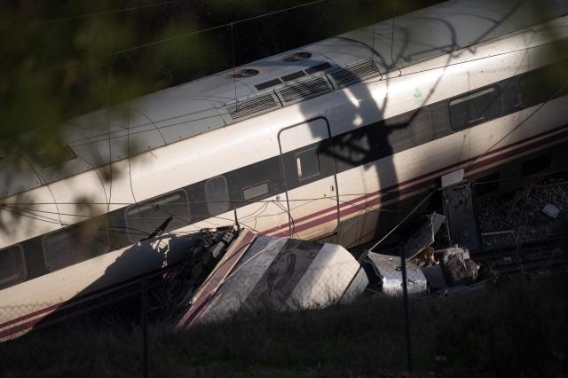 A picture taken on January 19, 2026 shows a view of one of the two trains that derailed the day before, killing at least 39 people and injuring more than 120, in Adamuz, southern Spain. At least 39 people died and more than 120 injured in the deadliest train accident in Spain in over a decade. The crash happened on January 18, 2026 evening when a train operated by rail company Iryo travelling from Malaga to Madrid derailed near Adamuz, crossing onto the other track where it crashed into an oncoming train, which also derailed. (Photo by JORGE GUERRERO / AFP)