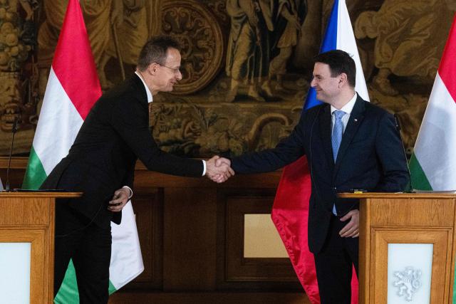 Czech Foreign Minister Petr Macinka (R) shakes hand with his Hungarian counterpart Peter Szijjarto after delivering a joint press conference on January 19, 2026 in Prague, Czech Republic. (Photo by Michal Cizek / AFP)
