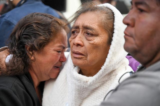 Relatives of a slain policeman mourn after a funeral ceremony at the Interior Ministry headquarters in Guatemala City on July 19, 2026. Guatemala's president on July 18 declared a 30-day nationwide state of emergency to combat criminal gangs after authorities accused the groups of killing eight police officers and holding hostages at three prisons. The killings occurred in the Guatemalan capital and surrounding areas a day after gang-affiliated inmates took 46 people hostage in the three prisons across the country to demand incarcerated gang leaders be moved to lower-security facilities. (Photo by JOHAN ORDONEZ / AFP)