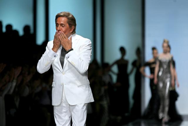 (FILES) Italian haute couture designer Valentino acknowledges the applause after his fashion show to mark 45 years in business, in Rome on July 7, 2007. Italian designer Valentino Garavani has died at age 93, Italy's ANSA news agency reported on January 19, 2026.  The giant in the world of haute couture died at his home in Rome, the agency reported, citing the Valentino Garavani Foundation and the designer's longtime partner, Giancarlo Giammetti. (Photo by Filippo MONTEFORTE / AFP)