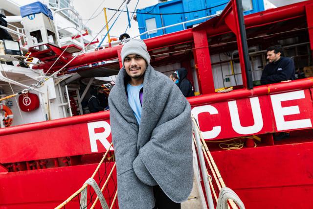 A rescued migrant disembarks from the rescue ship "Ocean Viking" operated by the NGO SOS Mediterranee, at the port of Palermo, southern Italy, on January 19, 2026. The humanitarian ship Ocean Viking rescued 90 migrants in the Mediterranean Sea before docking at the port of Palermo, Italy, where they were received by port authorities and the Italian Red Cross. (Photo by Sameer Al-DOUMY / AFP)
