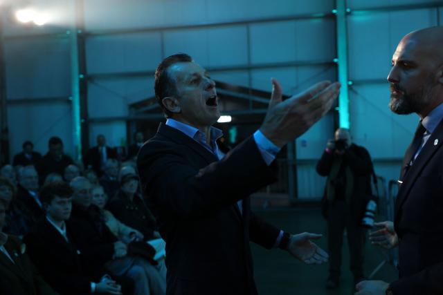 A member of the audience heckles as Reform UK MP for Newark Robert Jenrick addresses delegates during a Reform UK party political rally at Newark Showground in Newark upon Trent, central England, on January 19, 2026. (Photo by Darren Staples / AFP)