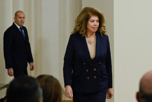 Bulgaria's Vice President Iliana Iotova walks in front of Rumen Radev prior his press conference to announce his resignation in Sofia on January 19, 2026. The Balkan country, which introduced the euro on January 1, was plunged into fresh political turmoil after a series of widespread anti-corruption protests swept a conservative-led government from office in mid-December. (Photo by Nikolay DOYCHINOV / AFP)