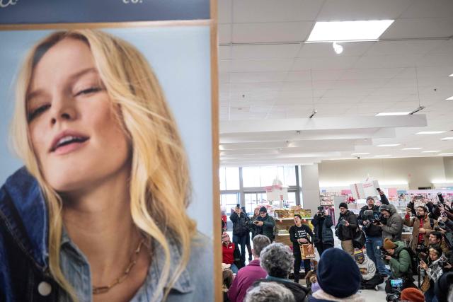 A small crowd of protesters sing along during a sit-in in a Target store as they denounce what they say is complicity by the store to allow Immigration and Customs Enforcement (ICE) agents to come into the store and stage in their parking lot in Saint Paul, Minnesota, on January 19, 2026. A US judge restricted federal agents on January 16 from interfering with peaceful protesters in Minnesota, after President Donald Trump said there was no immediate need to invoke the Insurrection Act over the demonstrations. (Photo by ROBERTO SCHMIDT / AFP)