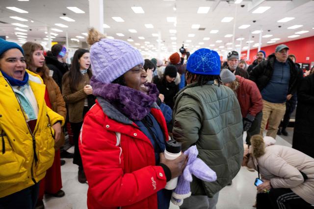 A small crowd of protesters sing along during a sit-in in a Target store as they denounce what they say is complicity by the store to allow Immigration and Customs Enforcement (ICE) agents to come into the store and stage in their parking lot in Saint Paul, Minnesota, on January 19, 2026. A US judge restricted federal agents on January 16 from interfering with peaceful protesters in Minnesota, after President Donald Trump said there was no immediate need to invoke the Insurrection Act over the demonstrations. (Photo by ROBERTO SCHMIDT / AFP)