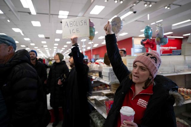 A small crowd of protesters sing along during a sit-in in a Target store as they denounce what they say is complicity by the store to allow Immigration and Customs Enforcement (ICE) agents to come into the store and stage in their parking lot in Saint Paul, Minnesota, on January 19, 2026. A US judge restricted federal agents on January 16 from interfering with peaceful protesters in Minnesota, after President Donald Trump said there was no immediate need to invoke the Insurrection Act over the demonstrations. (Photo by ROBERTO SCHMIDT / AFP)