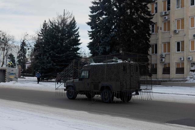 This photograph shows a Ukrainian military vehicle encased with anti-drone netting at an undisclosed location in eastern Ukraine on January 19, 2026, amid the Russian invasion of Ukraine. (Photo by Tetiana DZHAFAROVA / AFP)