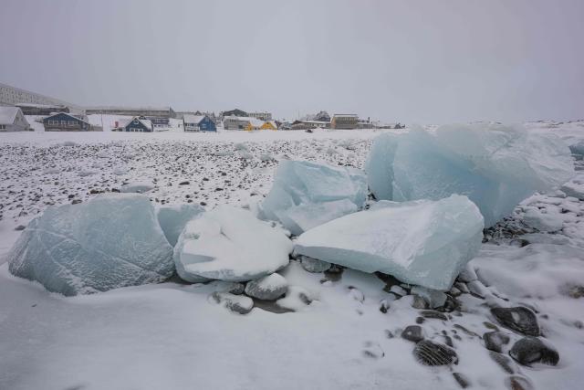 Ice blocks lie along the shoreline with residential buildings in the background in Nuuk, Greenland, on January 19, 2026 (Photo by Jonathan NACKSTRAND / AFP)