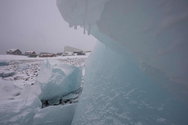 Ice blocks lie along the shoreline with residential buildings in the background in Nuuk, Greenland, on January 19, 2026 (Photo by Jonathan NACKSTRAND / AFP)