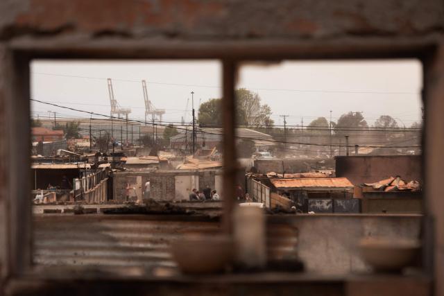 Residents of the Gabriela Mistral neighborhood clear debris from their burnt homes after a wildfire in Lirquen, Chile, on January 19, 2026. Wildfires that have killed 19 people in southern Chile and wiped out entire towns, raged for a third day on January 19, fanned by high temperatures and strong winds at the height of the southern hemisphere summer. (Photo by Raul BRAVO / AFP)