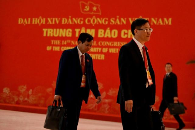 Delegates arrive to attend the opening ceremony of the 14th National Congress of the Communist Party of Vietnam at the National Convention Centre in Hanoi on January 20,2026. (Photo by Nhac NGUYEN / AFP)