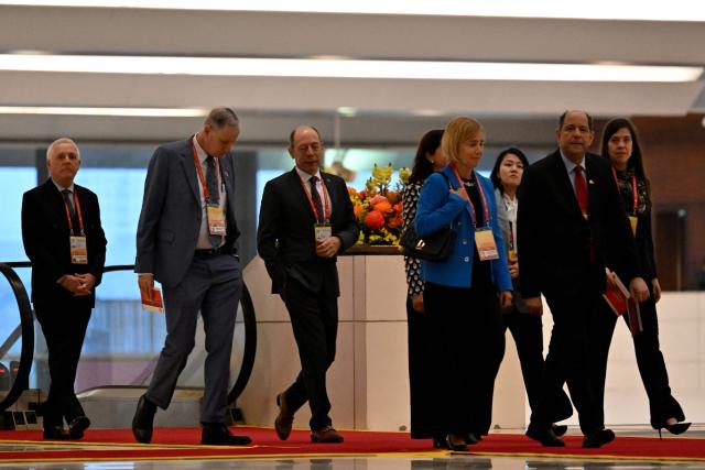 Delegates arrive to attend the opening ceremony of the 14th National Congress of the Communist Party of Vietnam at the National Convention Centre in Hanoi on January 20,2026. (Photo by Nhac NGUYEN / AFP)
