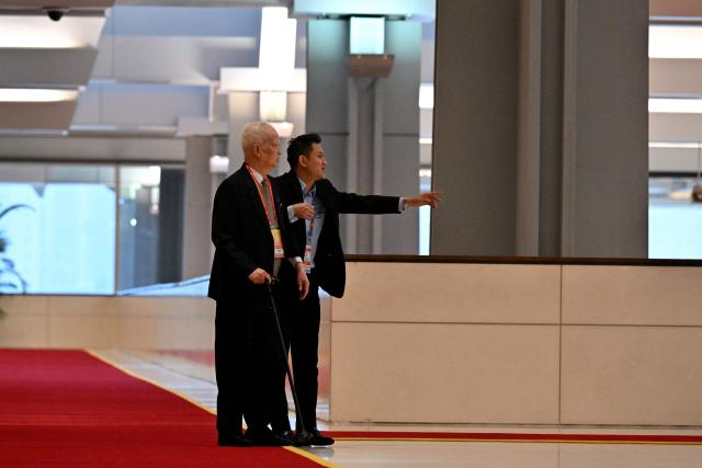 Delegates arrive to attend the opening ceremony of the 14th National Congress of the Communist Party of Vietnam at the National Convention Centre in Hanoi on January 20,2026. (Photo by Nhac NGUYEN / AFP)