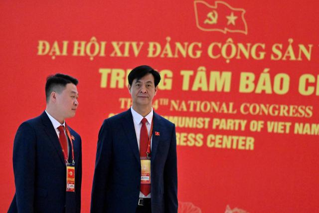 Delegates arrive to attend the opening ceremony of the 14th National Congress of the Communist Party of Vietnam at the National Convention Centre in Hanoi on January 20,2026. (Photo by Nhac NGUYEN / AFP)