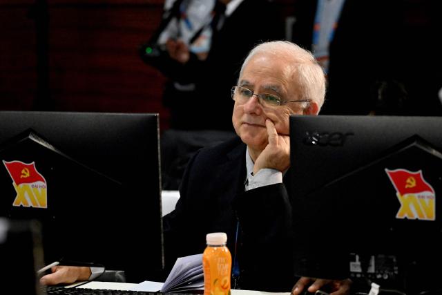 A foreign reporter listens to the opening session during the opening ceremony of the 14th National Congress of the Communist Party of Vietnam at the National Convention Centre in Hanoi on January 20, 2026. (Photo by Nhac NGUYEN / AFP)