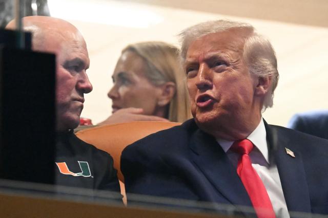 US President Donald Trump speaks with Dana White, CEO of the  Ultimate Fighting Championship (UFC), while attending the College Football National Championship Game between the Miami Hurricanes and the Indiana Hoosiers at Hard Rock Stadium in Miami Gardens, Florida, on January 19, 2026. (Photo by ANDREW CABALLERO-REYNOLDS / AFP)