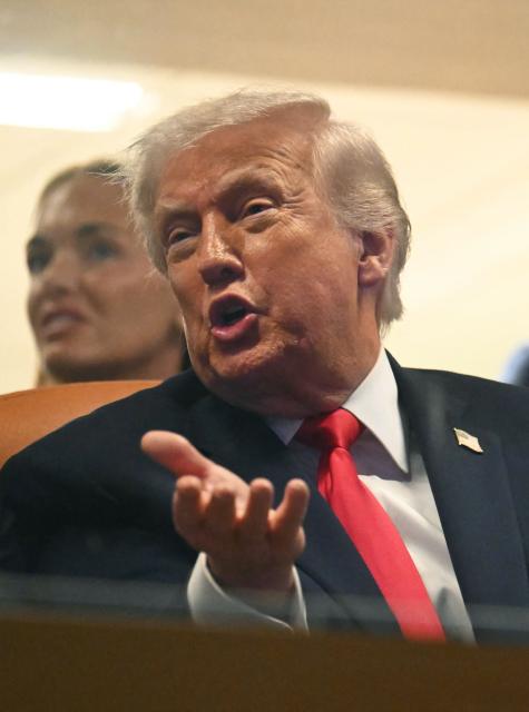 US President Donald Trump attends the College Football National Championship Game between the Miami Hurricanes and the Indiana Hoosiers at Hard Rock Stadium in Miami Gardens, Florida, on January 19, 2026. (Photo by ANDREW CABALLERO-REYNOLDS / AFP)