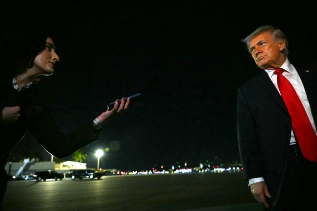 US President Donald Trump speaks with reporters before boarding Air Force One at Palm Beach International Airport, in West Palm Beach, Florida on January 19, 2026. President Trump is returning to Washington after spending the weekend at his Mar-a-Lago residence and attending the College Football National Championship Game between Miami Hurricanes and Indiana Hoosiers at Hard Rock Stadium in Miami Gardens, Florida. (Photo by ANDREW CABALLERO-REYNOLDS / AFP)