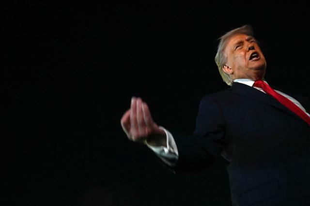US President Donald Trump speaks with reporters before boarding Air Force One at Palm Beach International Airport, in West Palm Beach, Florida on January 19, 2026. President Trump is returning to Washington after spending the weekend at his Mar-a-Lago residence and attending the College Football National Championship Game between Miami Hurricanes and Indiana Hoosiers at Hard Rock Stadium in Miami Gardens, Florida. (Photo by ANDREW CABALLERO-REYNOLDS / AFP)