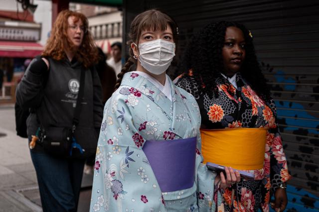 People visit a shopping street in Asakusa district near Sensoji Temple, a popular tourist location in Tokyo on January 20, 2026. A record number of tourists flocked to Japan in 2025, officials said on January 20, despite a steep fall in Chinese visitors in December as a diplomatic row between Beijing and Tokyo rumbled on. (Photo by Philip FONG / AFP)