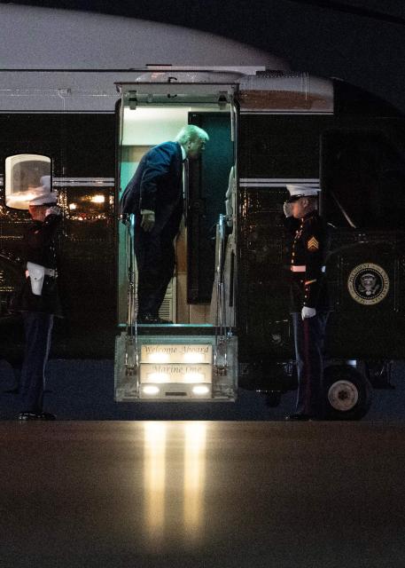 US President Donald Trump steps off Marine One before boarding Air Force One at Palm Beach International Airport, in West Palm Beach, Florida on January 19, 2026. President Trump is returning to Washington after spending the weekend at his Mar-a-Lago residence and attending the College Football National Championship Game between Miami Hurricanes and Indiana Hoosiers at Hard Rock Stadium in Miami Gardens, Florida. (Photo by ANDREW CABALLERO-REYNOLDS / AFP)