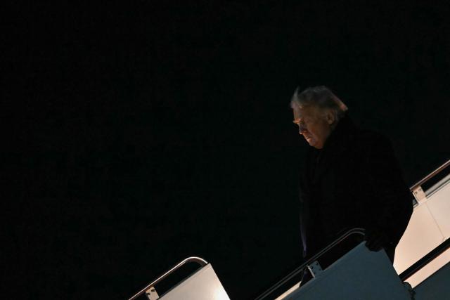 US President Donald Trump steps off Air Force One at Joint Base Andrews in Maryland in the early hours of January 20, 2026 after spending the weekend at his Mar-a-Lago residence and attending a college football game in Florida. Later in the day, President Trump will be heading to the Swiss ski resort of Davos to attend the World Economic Forum (WEF). (Photo by ANDREW CABALLERO-REYNOLDS / AFP)