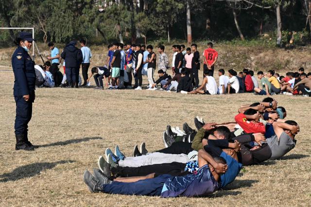 Youth applicants take part in a physical fitness test during a recruitment drive for temporary police jobs ahead of general elections in Kathmandu on January 20, 2026. (Photo by Prakash MATHEMA / AFP)