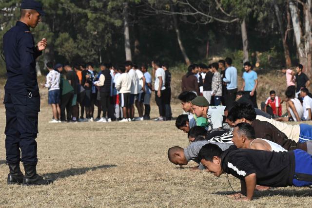 Youth applicants take part in a physical fitness test during a recruitment drive for temporary police jobs ahead of general elections in Kathmandu on January 20, 2026. (Photo by Prakash MATHEMA / AFP)