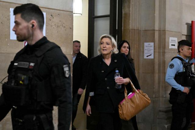 President of the parliamentary group of the French far-right Rassemblement National (RN) party, Marine Le Pen (C-L) accompanied by Rassemblement National MEP Catherine Griset (C-R) arrives for the hearing in the appeal trial of Rassemblement National (RN) parliamentary assistants on suspicion of embezzlement of European public funds at Paris courthouse in Paris on January 20, 2026. Marine Le Pen is called to the stand in the appeal trial in Paris of the parliamentary assistants of the National Front, where she is playing for her candidacy for the 2027 presidential election. Twelve of the accused, as well as the far-right party itself, have appealed against the verdict while another 12 people -- including one of Le Pen's sisters -- have decided to accept their convictions without appealing. (Photo by Bertrand GUAY / AFP)