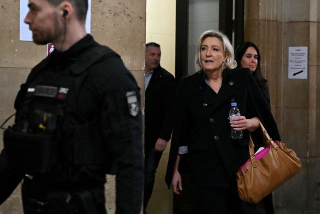 President of the parliamentary group of the French far-right Rassemblement National (RN) party, Marine Le Pen (2nd-R) accompanied by Rassemblement National MEP Catherine Griset (R) arrives for the hearing in the appeal trial of Rassemblement National (RN) parliamentary assistants on suspicion of embezzlement of European public funds at Paris courthouse in Paris on January 20, 2026. Marine Le Pen is called to the stand in the appeal trial in Paris of the parliamentary assistants of the National Front, where she is playing for her candidacy for the 2027 presidential election. Twelve of the accused, as well as the far-right party itself, have appealed against the verdict while another 12 people -- including one of Le Pen's sisters -- have decided to accept their convictions without appealing. (Photo by Bertrand GUAY / AFP)