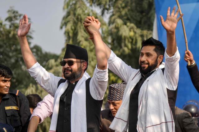 Rastriya Swatantra Party (RSP) election candidate and Kathmandu's former mayor Balendra Shah (L) and party chairman Rabi Lamichhane together raise their arms during a campaign rally in Janakpur on January 19, 2026. Shah, Nepal's rapper-turned-politician is carrying youth demands that helped topple last year's government into a head-to-head election battle with the veteran prime minister he helped unseat. Nepal will hold general elections on March 5, the first since mass anti-corruption protests in September 2025 overthrew KP Sharma Oli, a 73-year-old Marxist leader and four-term prime minister. (Photo by Sumit MISHRA / AFP)