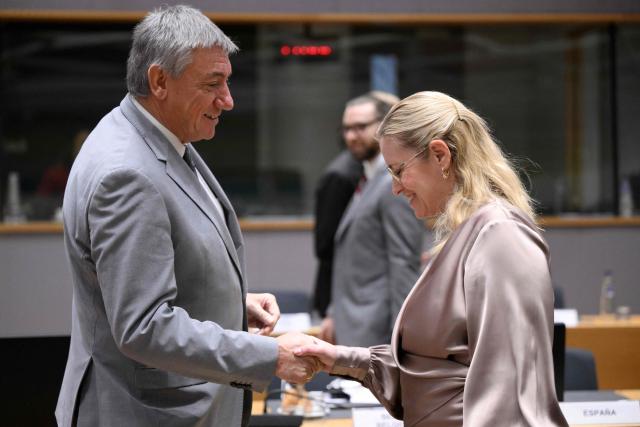 Belgium's Minister of Finance Jan Jambon (L) shakes hands with Denmark's Minister for Economic Affairs Stephanie Lose during the Ecofin Economic and Financial Affairs Council, at the EU headquarters in Brussels, on January 20, 2026. (Photo by JOHN THYS / AFP)
