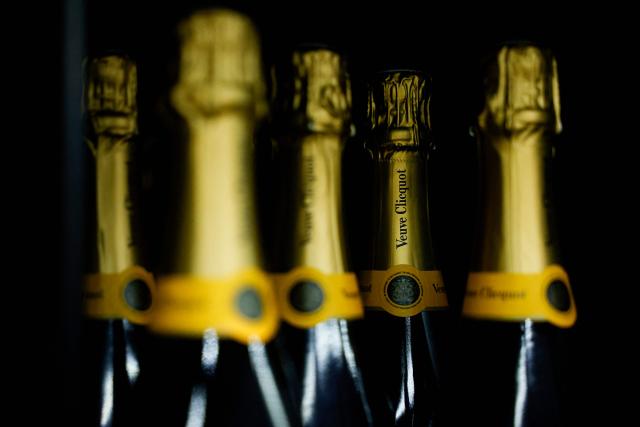 (FILES) This photograph shows bottles of Veuve Cliquot champagne displayed at the multinational wholesale chain METRO flagship store during a press visit in Nanterre, west of Paris, on December 17, 2025. US President Donald Trump on January 19, 2026 threatened 200 percent tariffs on French wine and champagne over France's intentions to decline the US leader's invitation to join his "Board of Peace." (Photo by Charlotte SIEMON / AFP)