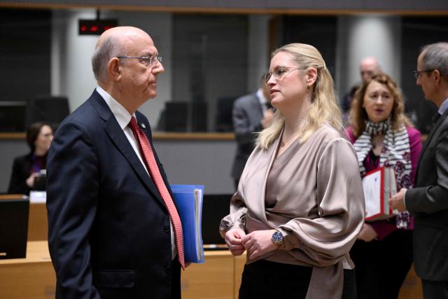 Cyprus's Finance Minister and Acting President of the Eurogroup Makis Keravnos (L) speaks with Denmark's Minister for Economic Affairs Stephanie Lose during the Ecofin Economic and Financial Affairs Council, at the EU headquarters in Brussels, on January 20, 2026. (Photo by JOHN THYS / AFP)