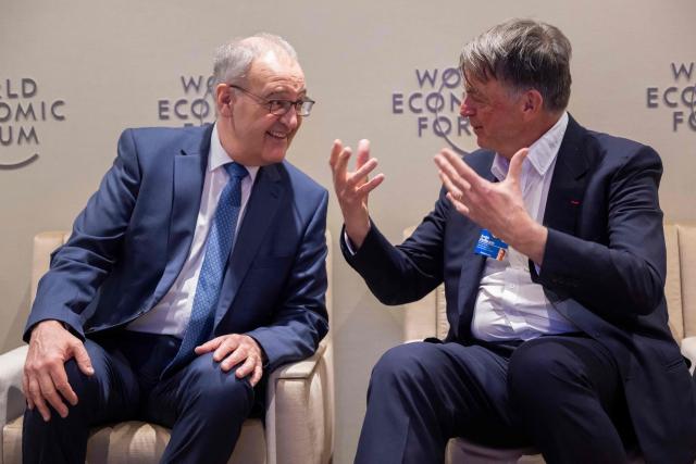 Switzerland's President Guy Parmelin (L) speaks with WEF co-chairman Andre Hoffmann during the World Economic Forum (WEF) annual meeting in Davos on January 20, 2026. The World Economic Forum takes place in Davos from January 19 to January 23, 2026. (Photo by LAURENT GILLIERON / POOL / AFP)