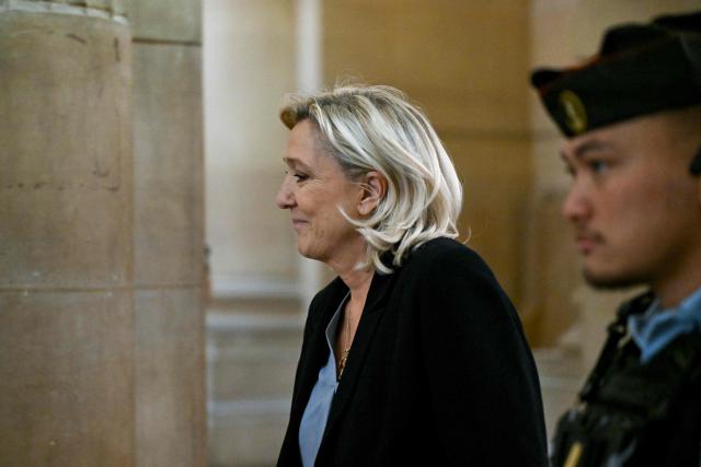 President of the parliamentary group of the French far-right Rassemblement National (RN) party, Marine Le Pen leaves the courtroom during a break of the hearing in the appeal trial of Rassemblement National (RN) parliamentary assistants on suspicion of embezzlement of European public funds at Paris courthouse in Paris on January 20, 2026. Marine Le Pen is called to the stand in the appeal trial in Paris of the parliamentary assistants of the National Front, where she is playing for her candidacy for the 2027 presidential election. Twelve of the accused, as well as the far-right party itself, have appealed against the verdict while another 12 people -- including one of Le Pen's sisters -- have decided to accept their convictions without appealing. (Photo by Bertrand GUAY / AFP)