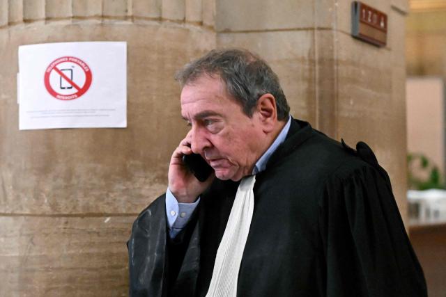 European parliament's lawyer Patrick Maisonneuve speaks on his mobile phone in a break during the hearing in the appeal trial of Rassemblement National (RN) parliamentary assistants on suspicion of embezzlement of European public funds at Paris courthouse in Paris on January 20, 2026. Marine Le Pen is called to the stand in the appeal trial in Paris of the parliamentary assistants of the National Front, where she is playing for her candidacy for the 2027 presidential election. Twelve of the accused, as well as the far-right party itself, have appealed against the verdict while another 12 people -- including one of Le Pen's sisters -- have decided to accept their convictions without appealing. (Photo by Bertrand GUAY / AFP)