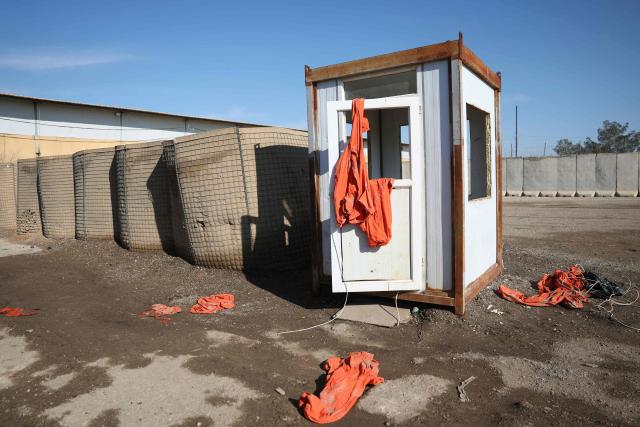 A photograph shows prisoners’ outfits left on the ground at the Ash Shaddadah prison after Syrian government forces took control of the facility in the countryside of the city of Hasakeh on January 20, 2026. The Syrian government and Kurdish forces traded accusations on January 19, over the fate of Islamic State (IS) group prisoners held in Kurdish-run facilities, as Syria's army deployed in the north and east under a recent deal. (Photo by OMAR HAJ KADOUR / AFP)