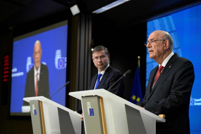 EU Commissioner for Economy and Productivity, Implementation and Simplification Valdis Dombrovskis (L) and Cyprus's Finance Minister and Acting President of the Eurogroup Makis Keravnos give a press conference during the Ecofin Economic and Financial Affairs Council, at the EU headquarters in Brussels, on January 20, 2026. (Photo by JOHN THYS / AFP)