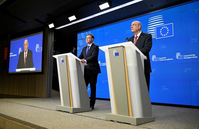 EU Commissioner for Economy and Productivity, Implementation and Simplification Valdis Dombrovskis (L) and Cyprus' Finance Minister and Acting President of the Eurogroup Makis Keravnos give a press conference during the Ecofin Economic and Financial Affairs Council, at the EU headquarters in Brussels, on January 20, 2026. (Photo by JOHN THYS / AFP)