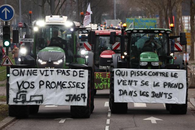A placard reads "you can't live on promises" (L) as European farmers gather outside the European Parliamen to protest against the free trade agreement between the European Union and the Mercosur countries, on the eve of a vote on a referral to the courts, in Strasbourg on January 20, 2026. Called by the FNSEA, France's leading national agricultural union, some 4,000 farmers from across the European Union, including Italy, Belgium, and Germany, are expected to attend the protest. MEPs will not vote on the entire agreement with Mercosur until the coming months, but they are set to vote on Wednesday on whether to refer the matter to the Court of Justice of the European Union (CJEU). (Photo by FREDERICK FLORIN / AFP)