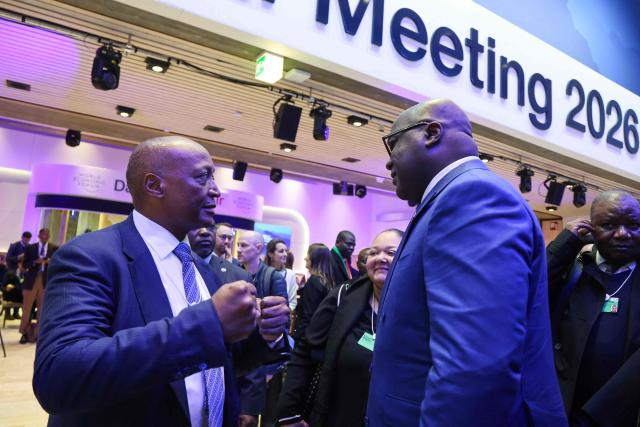 Confederation of African Football (CAF) President Patrice Motsepe (L) speaks with Democratic Republic of the Congo's President Felix Tshisekedi during the World Economic Forum (WEF) annual meeting in the Congress centre in Davos on January 20, 2026. The World Economic Forum takes place in Davos from January 19 to January 23, 2026. (Photo by Ludovic MARIN / AFP)