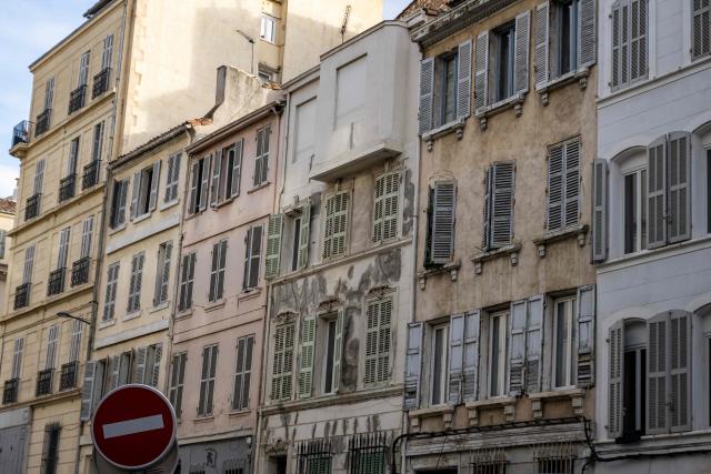 This photo shows buildings with facades in poor condition in downtown Marseille, southeastern France on January 20, 2026. (Photo by MIGUEL MEDINA / AFP)
