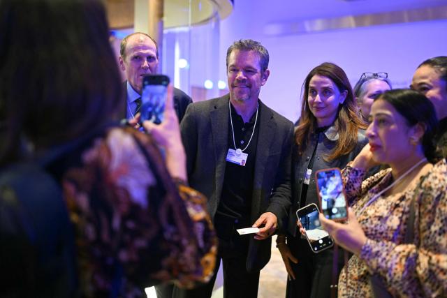 US actor Matt Damon (C) poses for selfies during the World Economic Forum (WEF) annual meeting in the Congress centre in Davos on January 20, 2026. The World Economic Forum takes place in Davos from January 19 to January 23, 2026. (Photo by Fabrice COFFRINI / AFP)