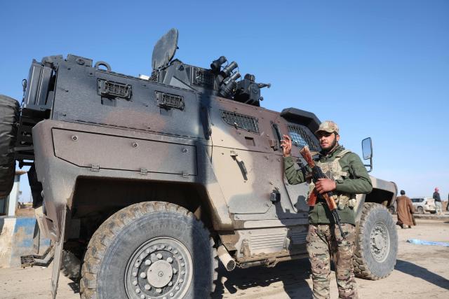 A soldier  of the Syrian government forces stands next to an armoured vehicle as they enter the city of Ash Shaddadah, south of the city of Hasakeh, in northeastern Syria on January 20, 2026. Negotiations between Syria's President and the head of the Kurdish-led Syrian Democratic Forces, have collapsed, a Kurdish official told AFP January 20. It came after rapid army gains in Kurdish-controlled territory, with the president refusing to concede on a push for decentralisation even while pledging to protect the minority's rights. (Photo by OMAR HAJ KADOUR / AFP)