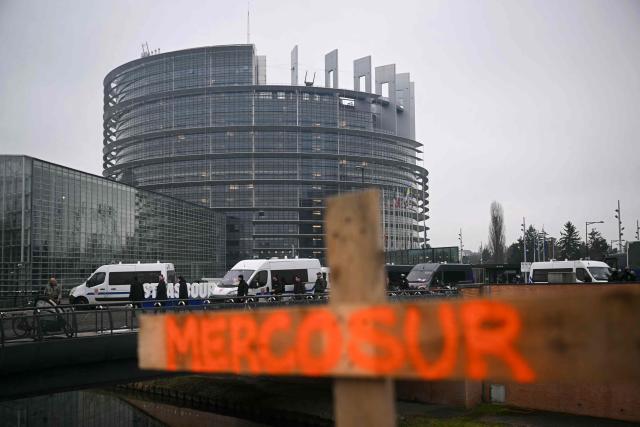The word MERCOSUR is written on a wooden cross during a protest by European farmers following the signing of the free trade agreement between the European Union and the Mercosur countries and on the eve of a vote on a referral to the courts, in front of the European Parliament in Strasbourg on January 20, 2026. Called by the FNSEA, France's leading national agricultural union, some 4,000 farmers from across the European Union, including Italy, Belgium, and Germany, are expected to attend the protest. MEPs will not vote on the entire agreement with Mercosur until the coming months, but they are set to vote on Wednesday on whether to refer the matter to the Court of Justice of the European Union (CJEU). (Photo by NICOLAS TUCAT / AFP)