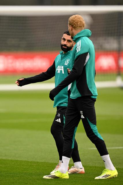 Liverpool's Egyptian striker #11 Mohamed Salah talks to Liverpool's French striker #22 Hugo Ekitike during a team training session at their training ground in Kirkby, Liverpool, north-west England on January 20, 2026, on the eve of their UEFA Champions League, league phase football match against Olympique Marseille in Marseille. (Photo by Oli SCARFF / AFP)