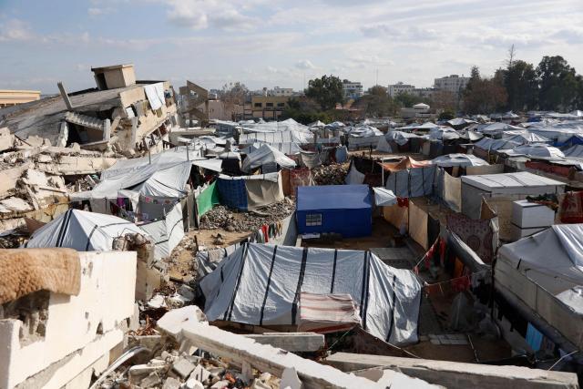 A general view shows tents housing displaced people in Gaza City on January 20, 2026. Day-to-day living conditions for the vast majority of Gaza residents remain extremely precarious, with more than 80 percent of infrastructure destroyed, according to the United Nations. Several humanitarian and UN workers told AFP that while the situation has improved in some areas since the ceasefire, the humanitarian response remains insufficient due to access restrictions imposed by Israeli authorities -- who deny these claims. Water and electricity networks, as well as waste management, no longer function. (Photo by Omar AL-QATTAA / AFP)