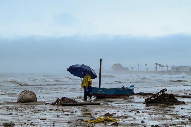 A fisherman secures his small fishing boat, in La Goulette near the capital Tunis, on Januray 20, 2026. Flooding across Tunisia has killed three people, authorities said January 20, with one official reporting a "critical" situation as parts of the North African country experienced their heaviest rainfall in more than 70 years. (Photo by FETHI BELAID / AFP)