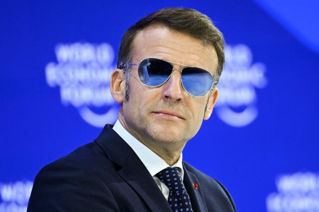 TOPSHOT - France's President Emmanuel Macron looks on during the World Economic Forum (WEF) annual meeting in Davos on January 20, 2026. The World Economic Forum takes place in Davos from January 19 to January 23, 2026. (Photo by Fabrice COFFRINI / AFP)